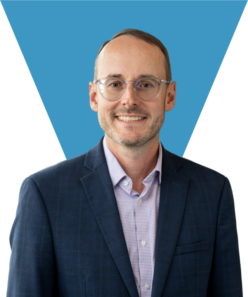 A professional headshot of Dr. T.A. Dickel